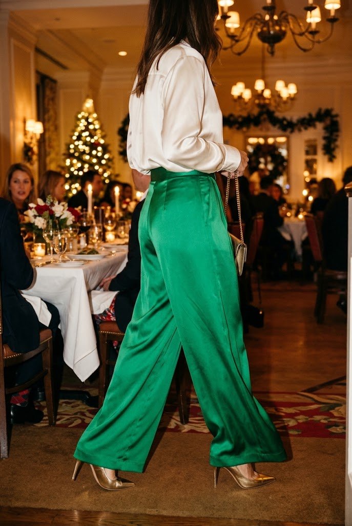 Emerald green satin wide leg trousers with ivory silk blouse for work christmas party outfit.