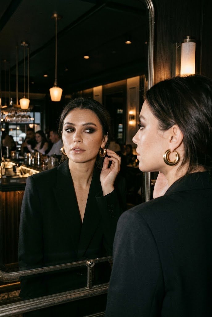 Smudged espresso smokey eye with glossy nude lip for holiday party makeup looks.